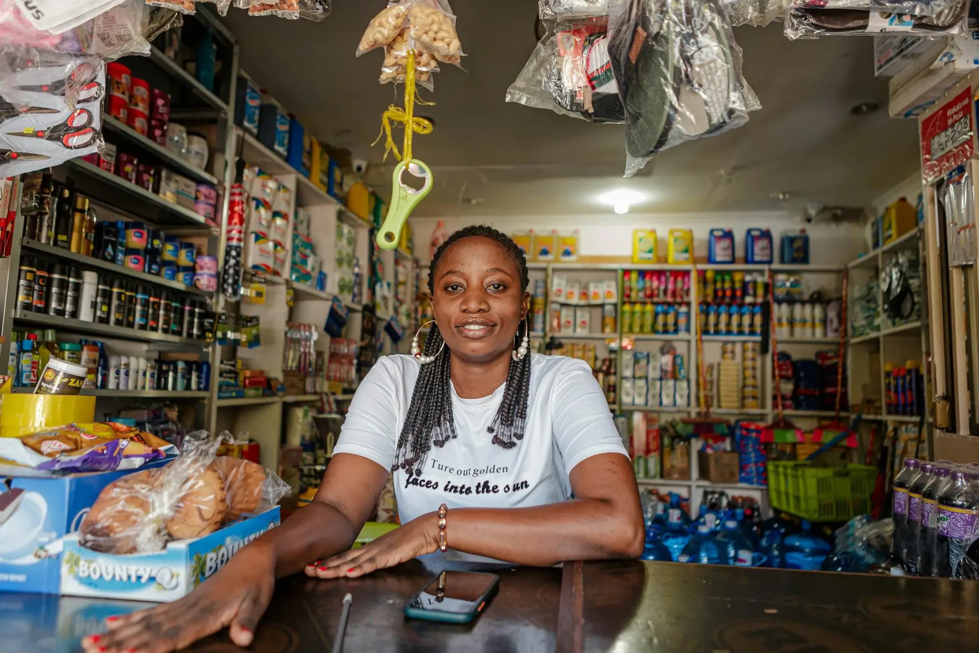Smiling shop owner behind the counter of her store